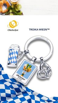 Mit Bierkrug, Brezn und dem offiziellen Wiesn™ Jahresmotiv
